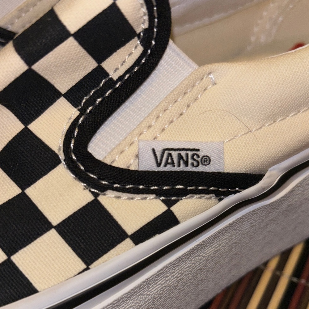 Vans Black and White Checkered Slip-On Sneakers.